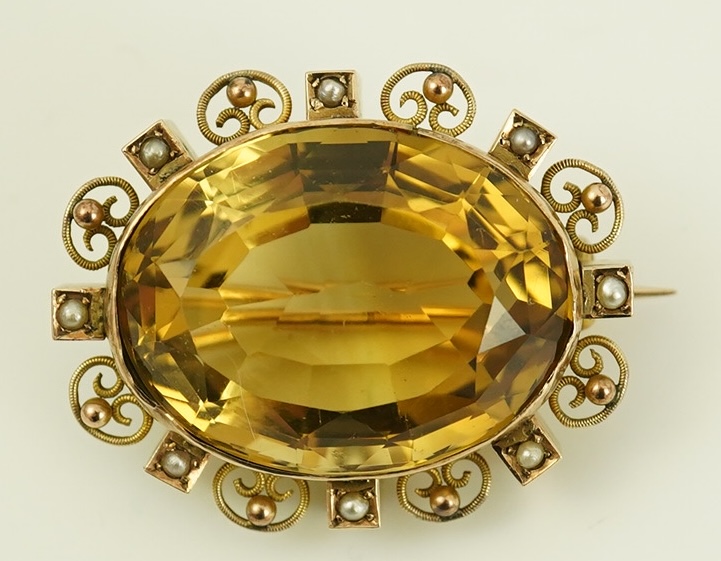 A late Victorian 9ct gold, citrine and seed pearl cluster set oval brooch